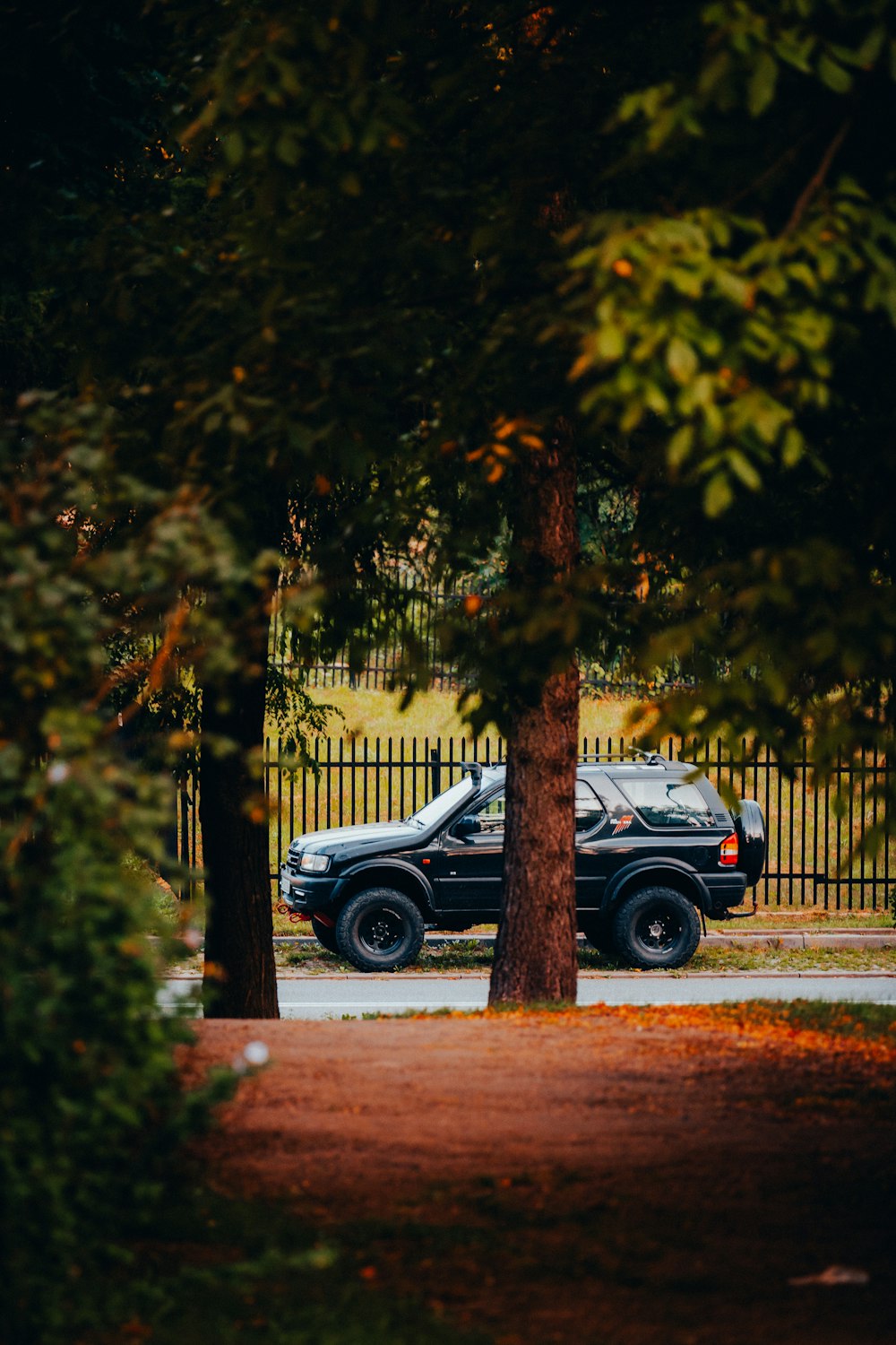 a truck is parked in front of a fence