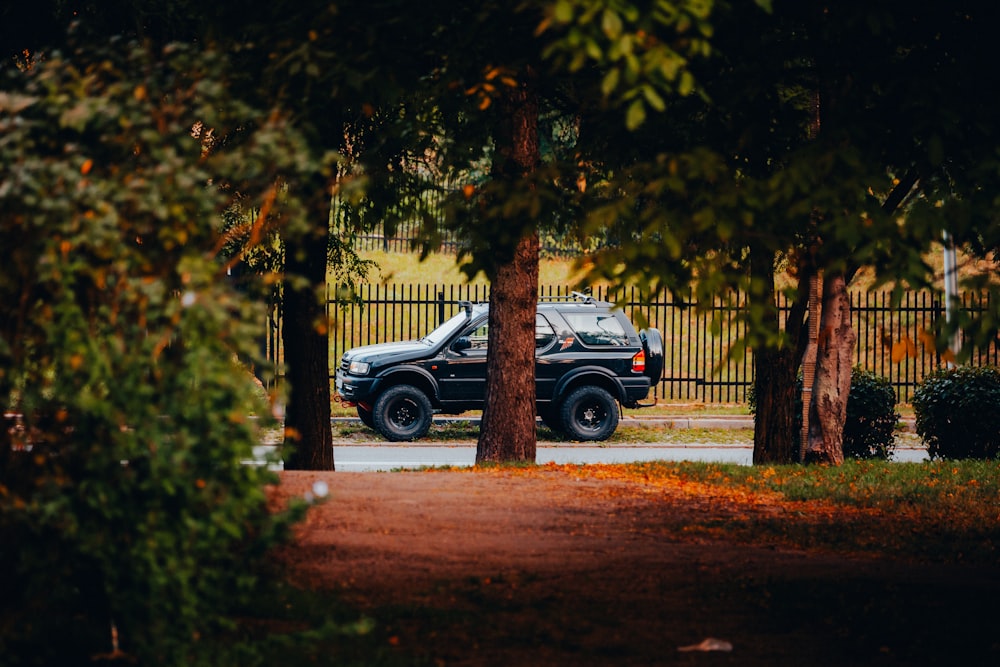 a truck is parked in front of a fence