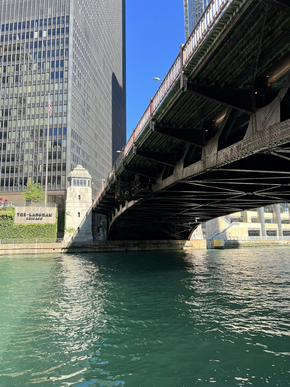 a bridge over a body of water in front of tall buildings