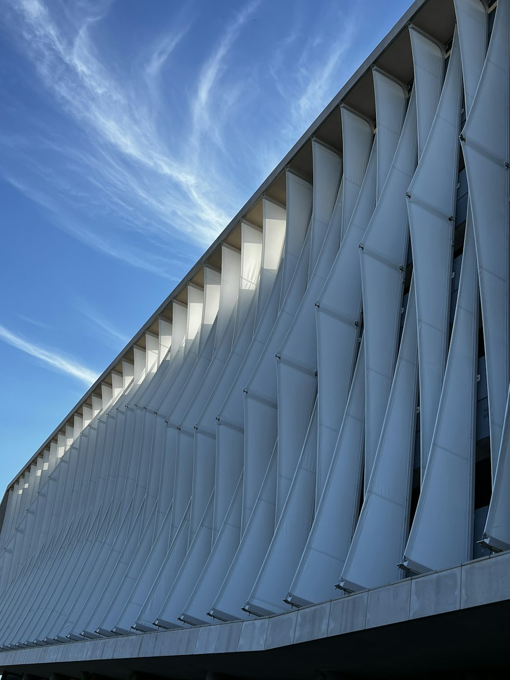 a large white building with a sky in the background