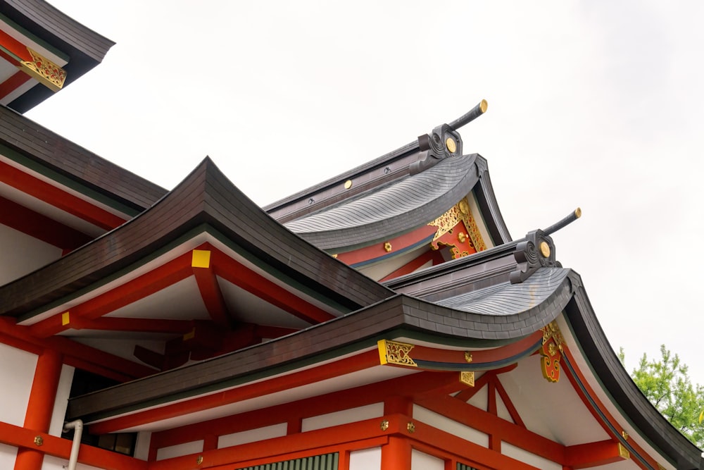 a red and white building with a black roof