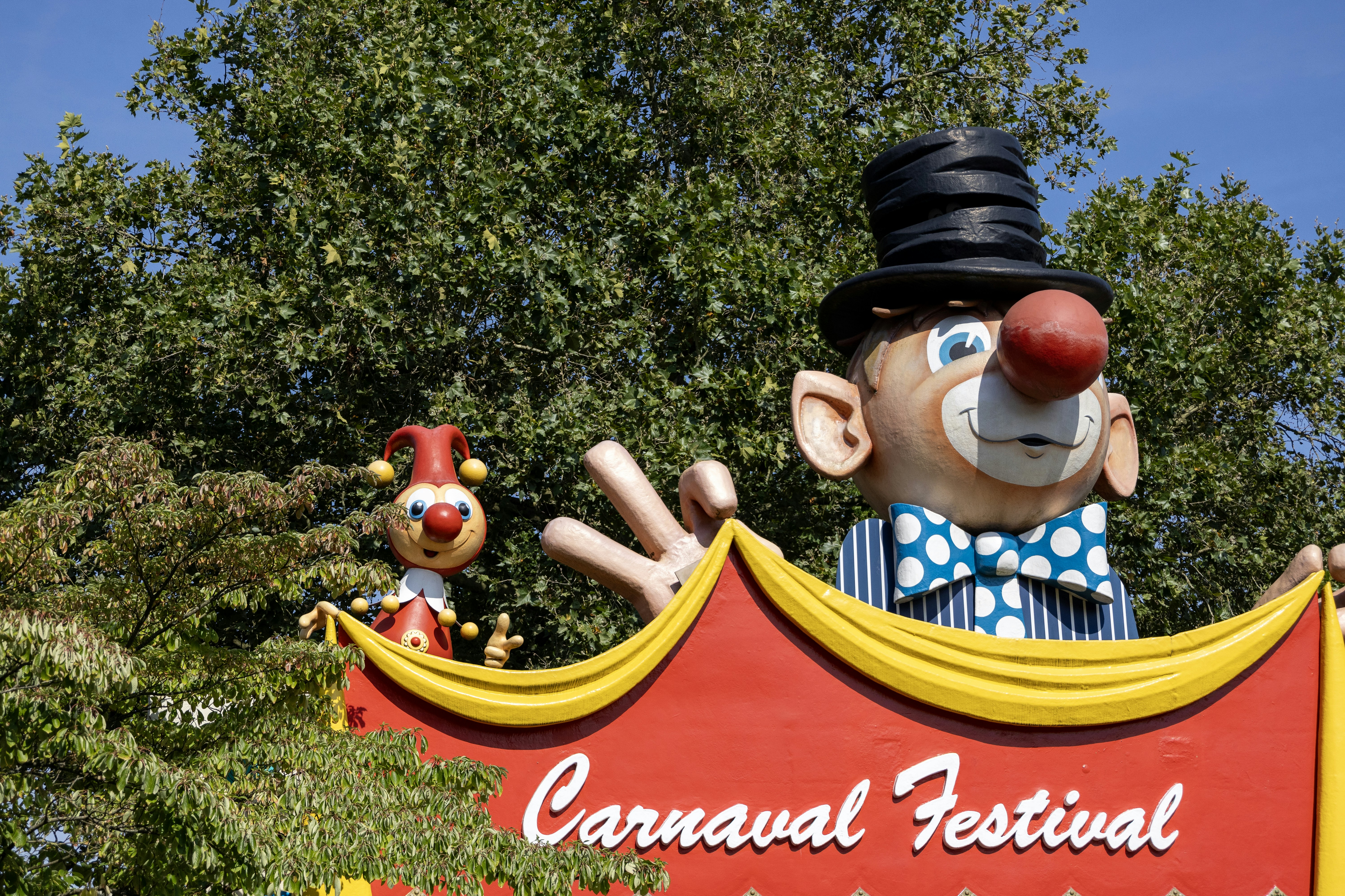 a carnival sign with a clown and clowns on it, Carnaval Festival Efteling