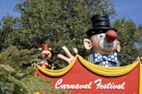 a carnival sign with a clown and clowns on it