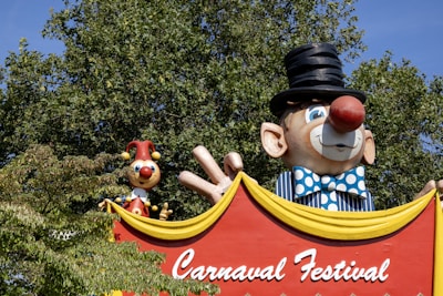 a carnival sign with a clown and clowns on it