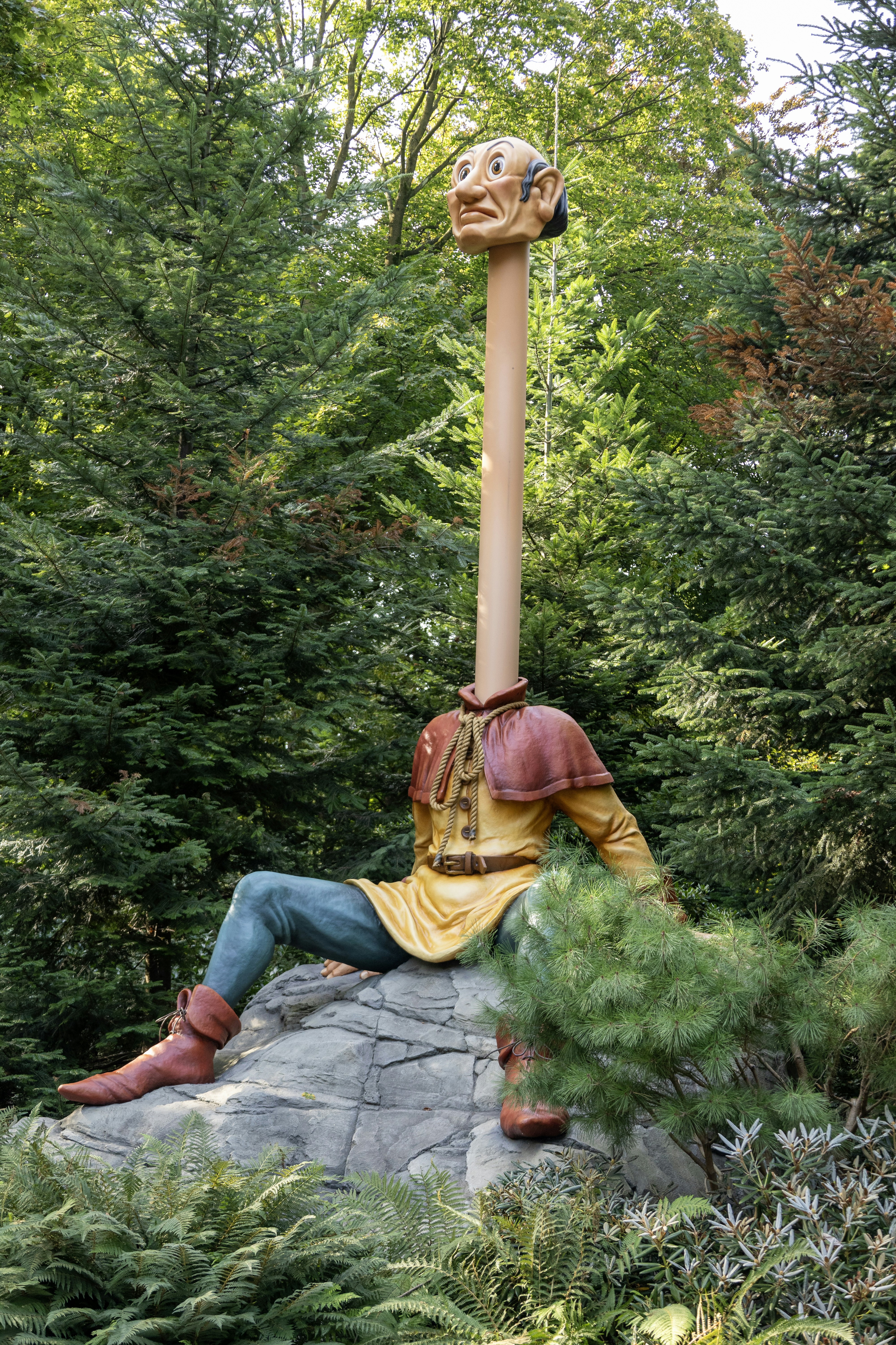 a statue of a man sitting on top of a rock