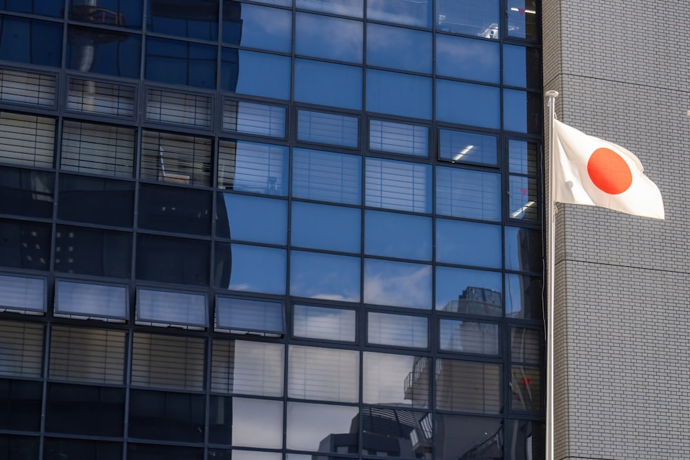 a japanese flag flying in front of a building