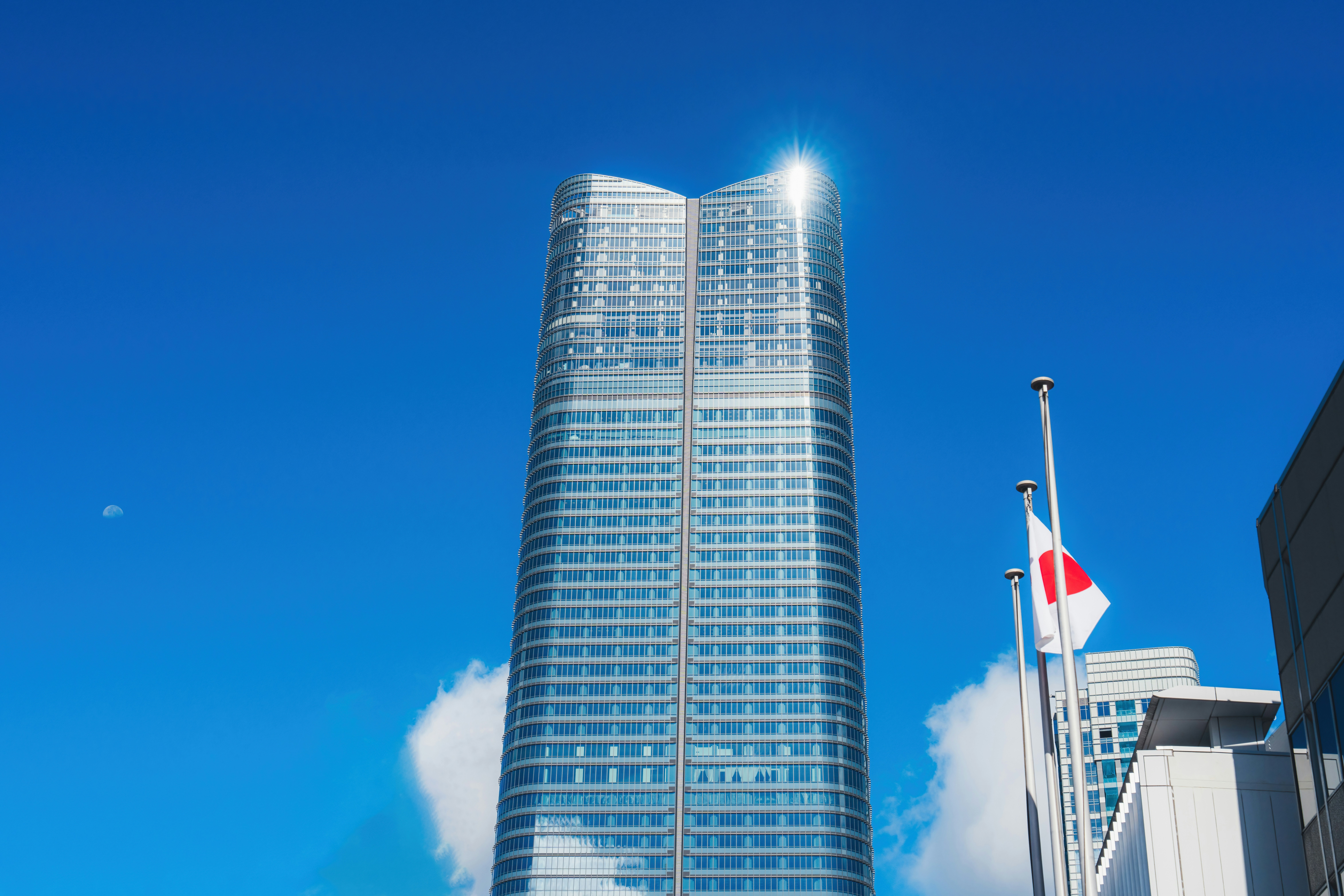 A tall building with a flag flying in front of it photo – Free ...