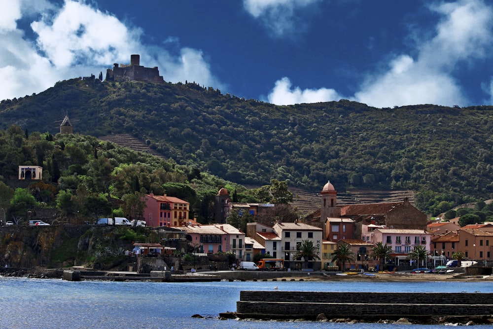 a small town on a hill overlooking a body of water