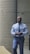 Close-up of a determined man walking through a minimalistic urban environment.