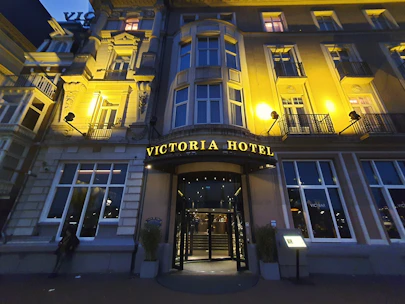 Front facade of a welcoming hotel with tasteful lighting at dusk.