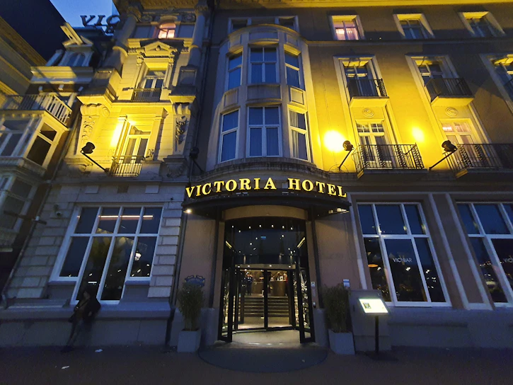 A grand entrance of Hotel Varanasi Residency bathed in warm golden light at dusk.