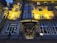 An elegant hotel facade with classical architectural details, warmly illuminated by exterior lights at dusk. The entrance is centrally located, featuring a curved awning with the hotel's name in illuminated letters. Tall windows are symmetrically arranged on the building's facade.