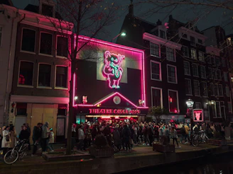 A lively urban night scene in Brussels with neon lights and nightlife.