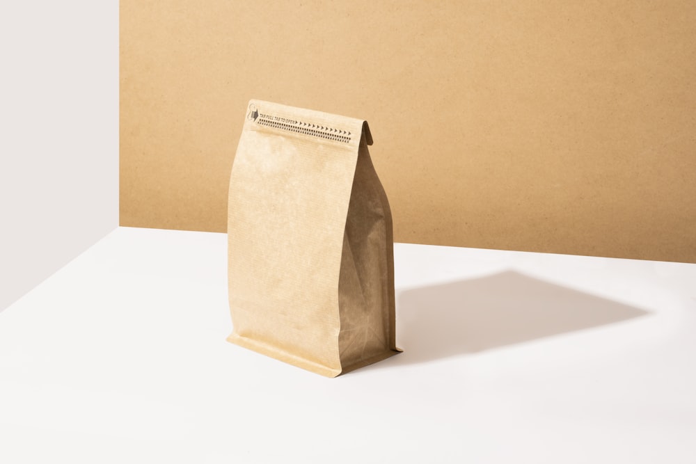 a brown paper bag sitting on top of a white table