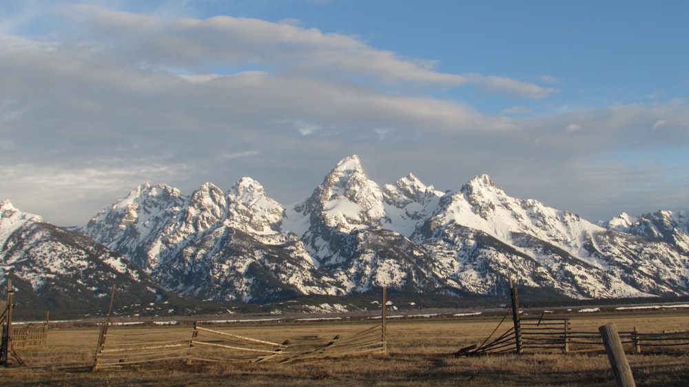 a fence in front of a mountain range