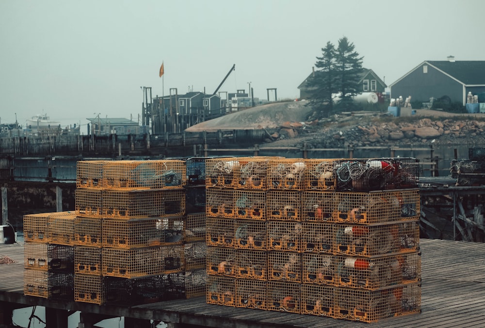 a pile of crates sitting on top of a wooden dock