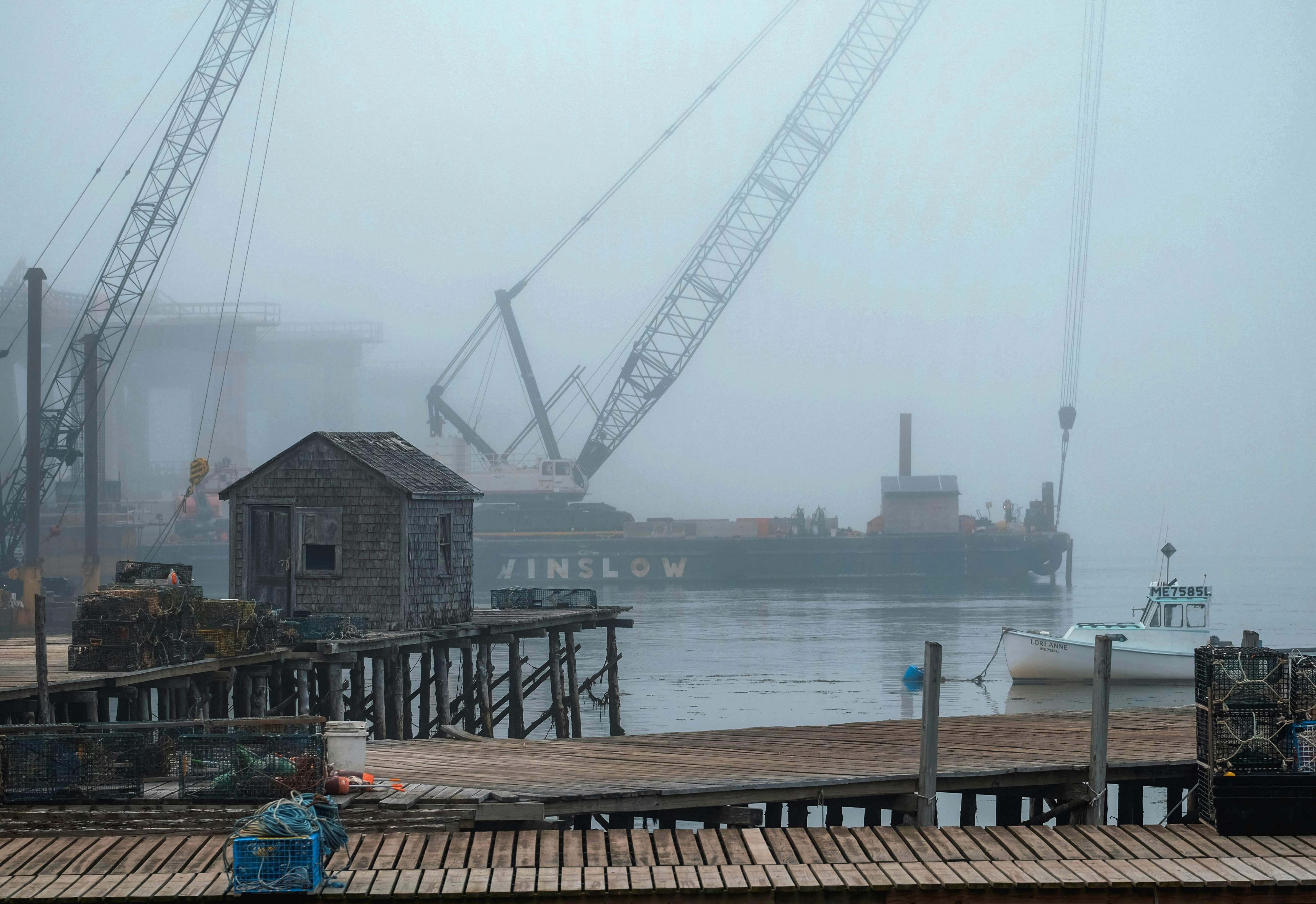 a boat is docked in a harbor on a foggy day