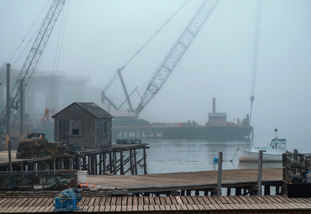 a boat is docked in a harbor on a foggy day