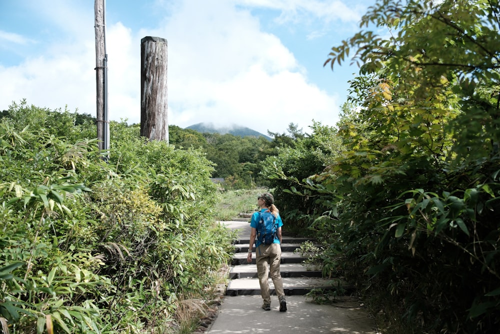 a person with a backpack walking down a path