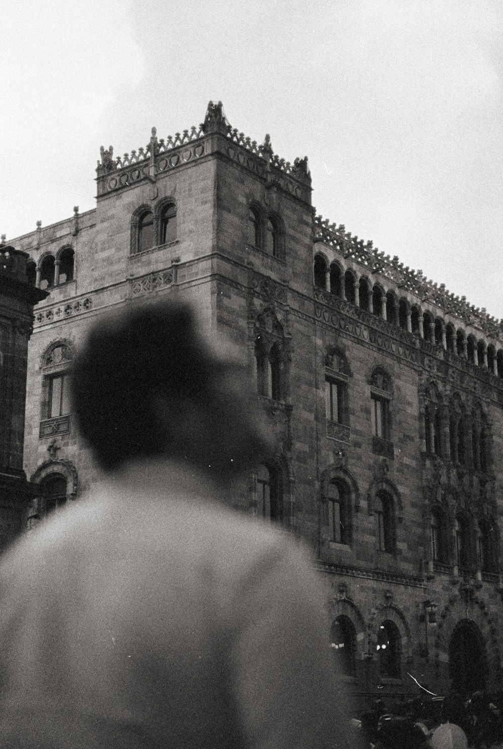 a man standing in front of a tall building