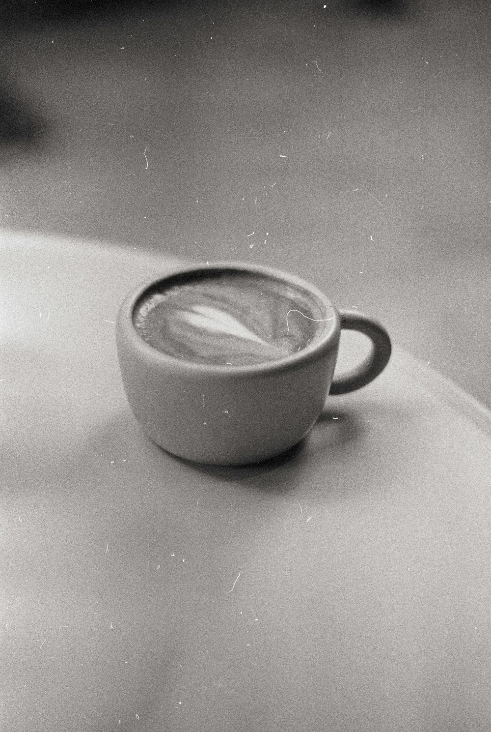 a cup of coffee sitting on top of a table