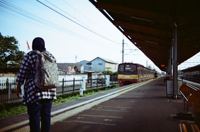 a man is waiting for a train at a train station