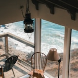 A cozy cruise cabin with a window view of the ocean waves.