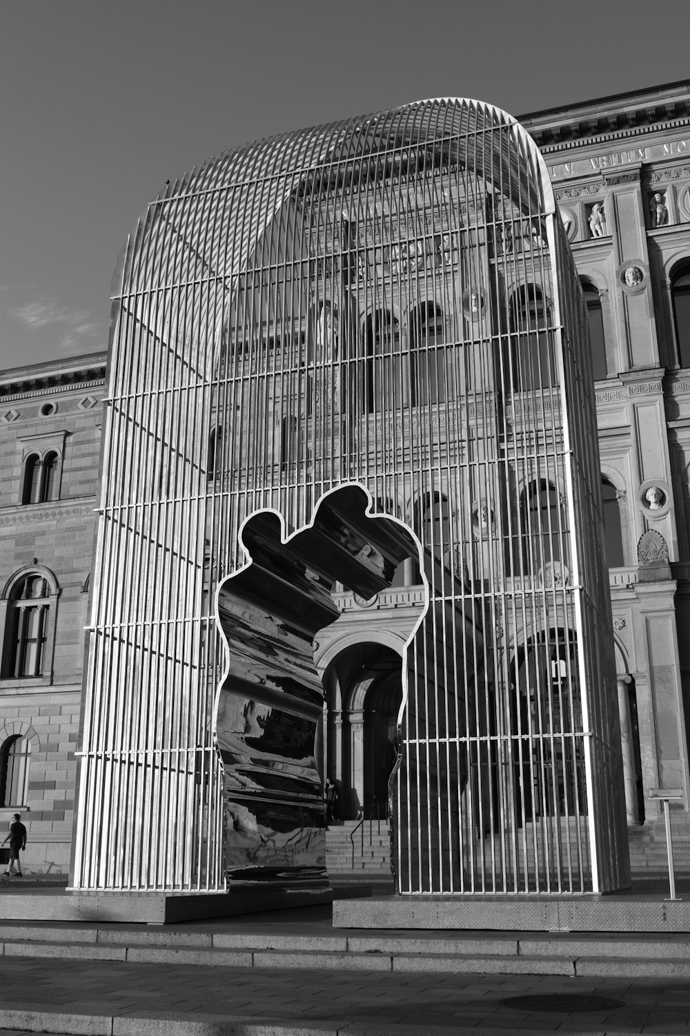 a black and white photo of a building with a birdcage