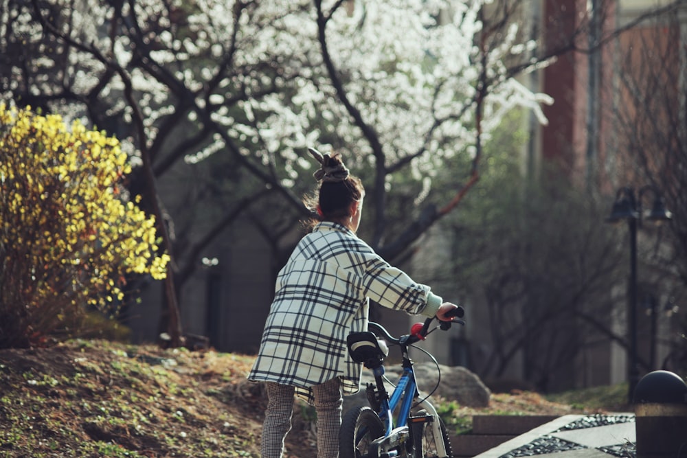 a woman riding a bike down a street