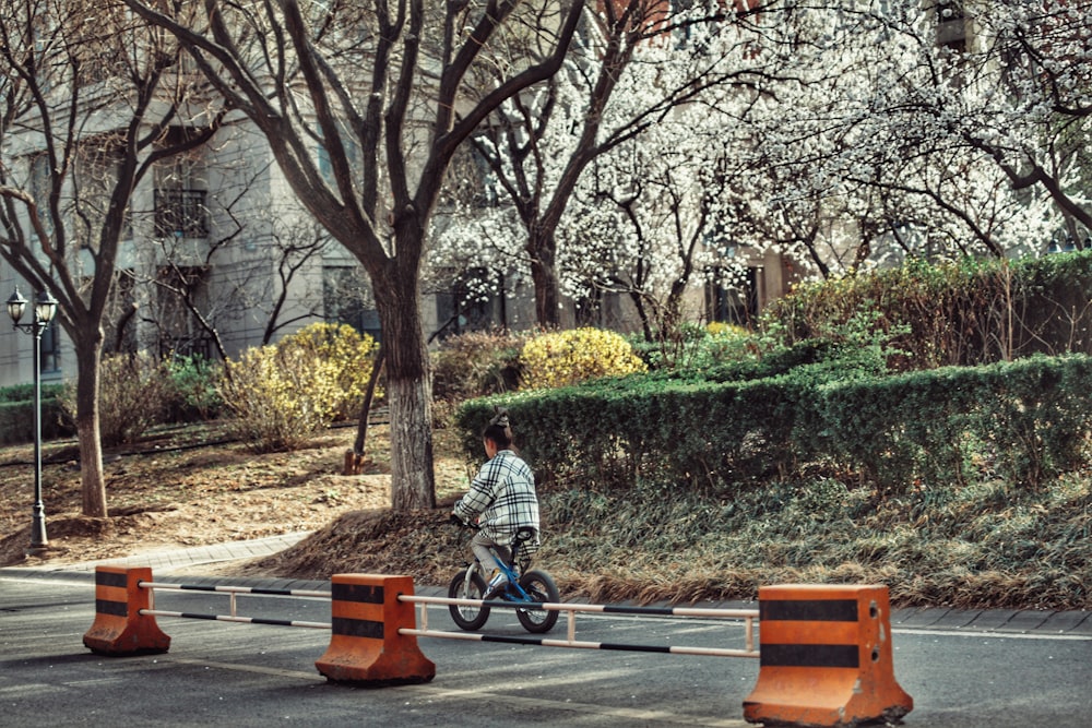 a person riding a bike on a city street