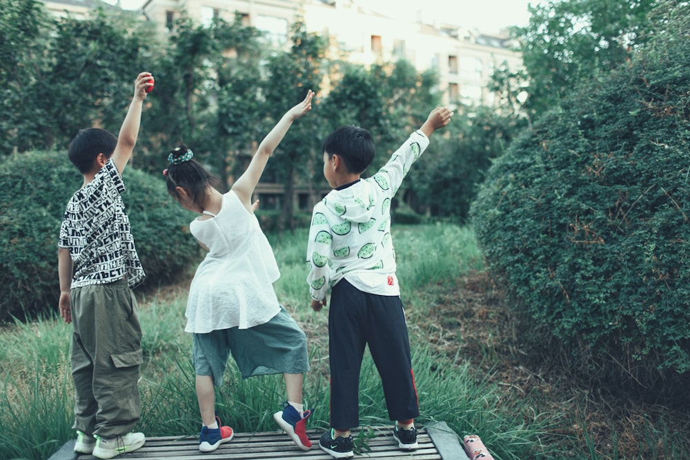 a group of young people standing on top of a wooden platform