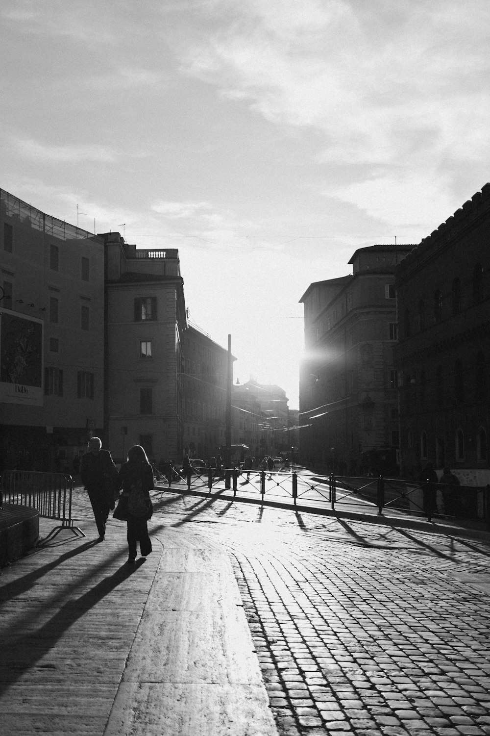 a couple of people that are walking down a street