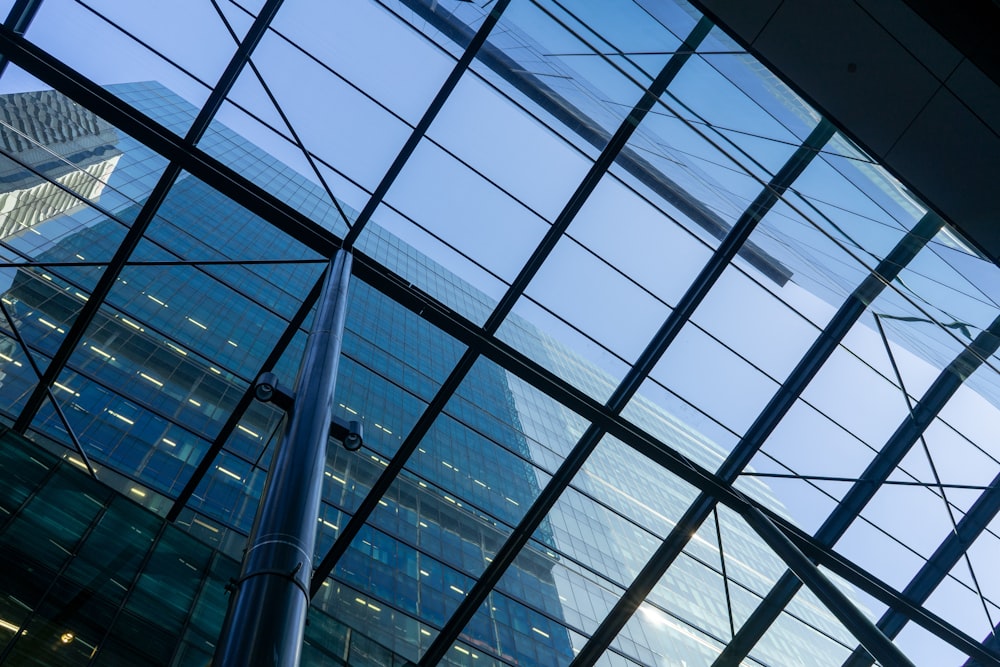 a tall building is reflected in the windows of another building