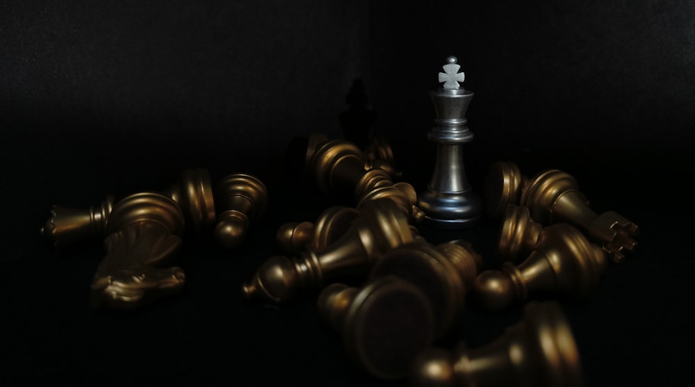 a black and gold chess set on a black background