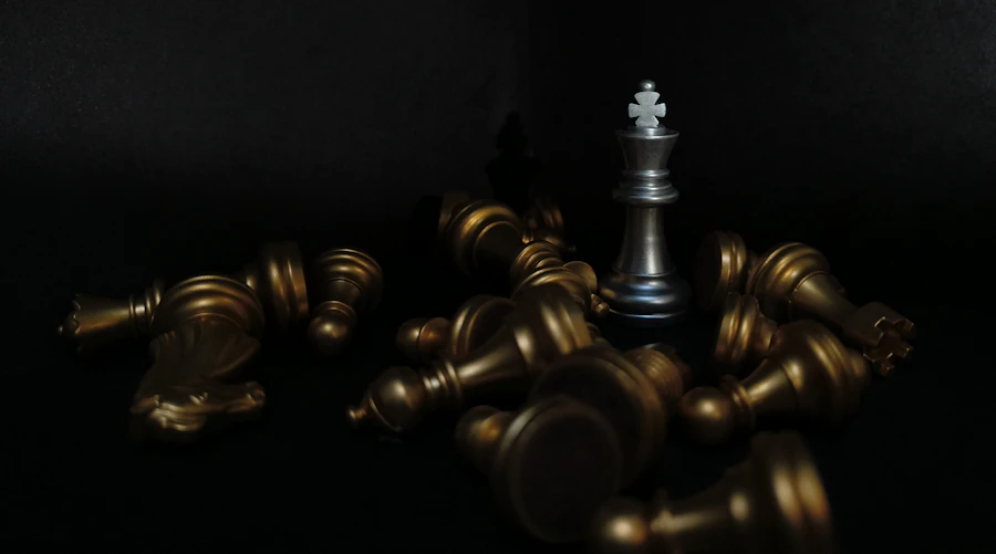 A black and gold chess set on a black background