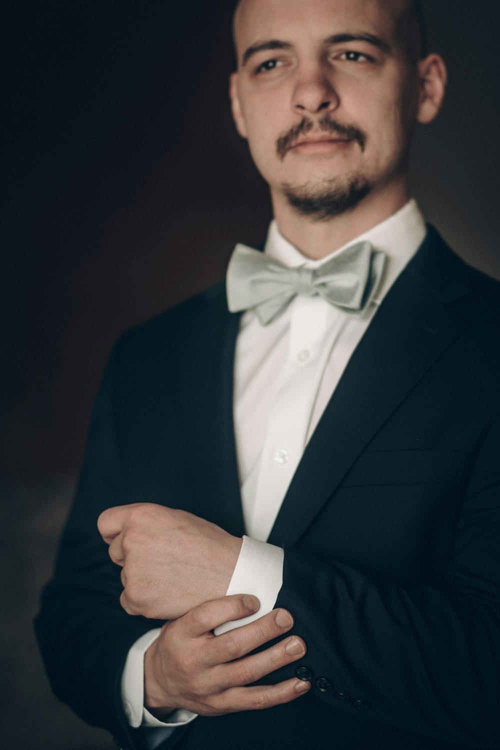 a man wearing a suit and bow tie