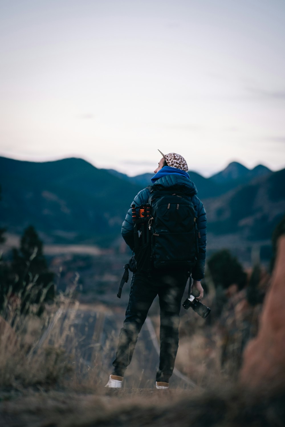 a man with a backpack walking through a field