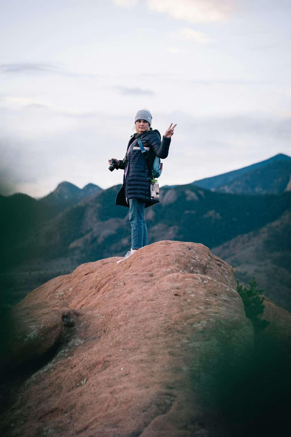 a person standing on top of a large rock