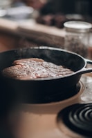 A cozy kitchen scene with a cast iron skillet sizzling on the stove.