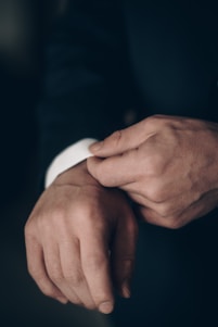 a close up of a person wearing a suit and tie