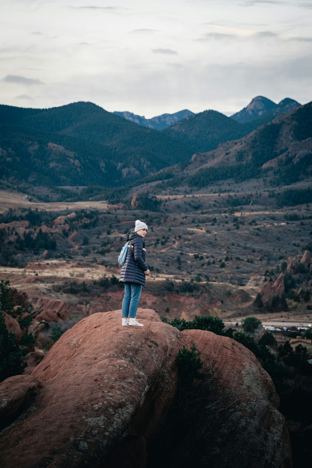 a person standing on top of a large rock