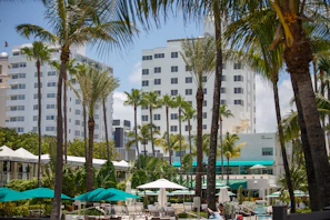 A wide shot of a colorful experiential marketing event with mid-century modern decor and palm trees under a sunny sky.