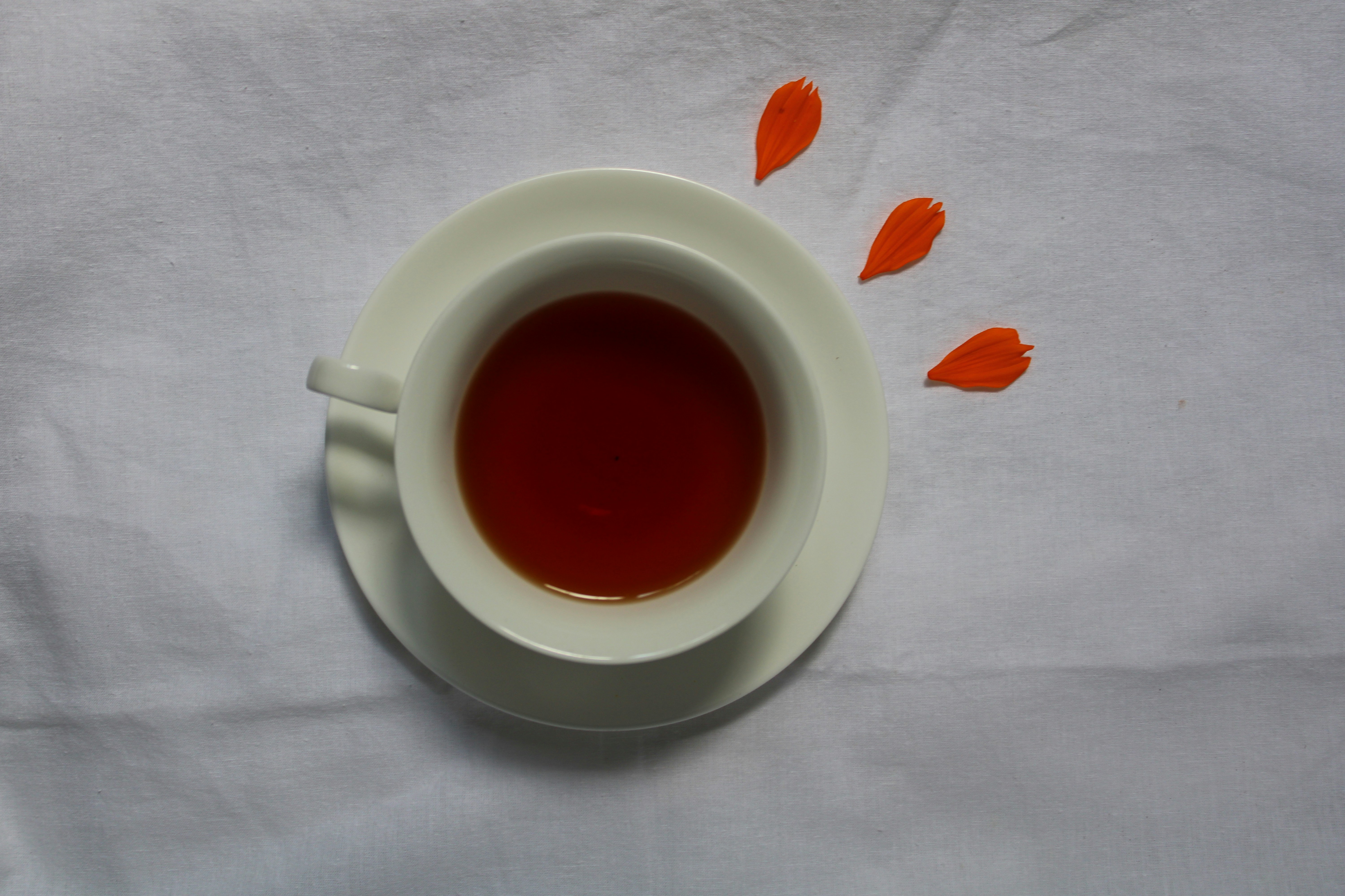 a cup of tea on a white table cloth