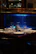 A sleek epoxy river table glowing under soft lighting in a cozy dining room.