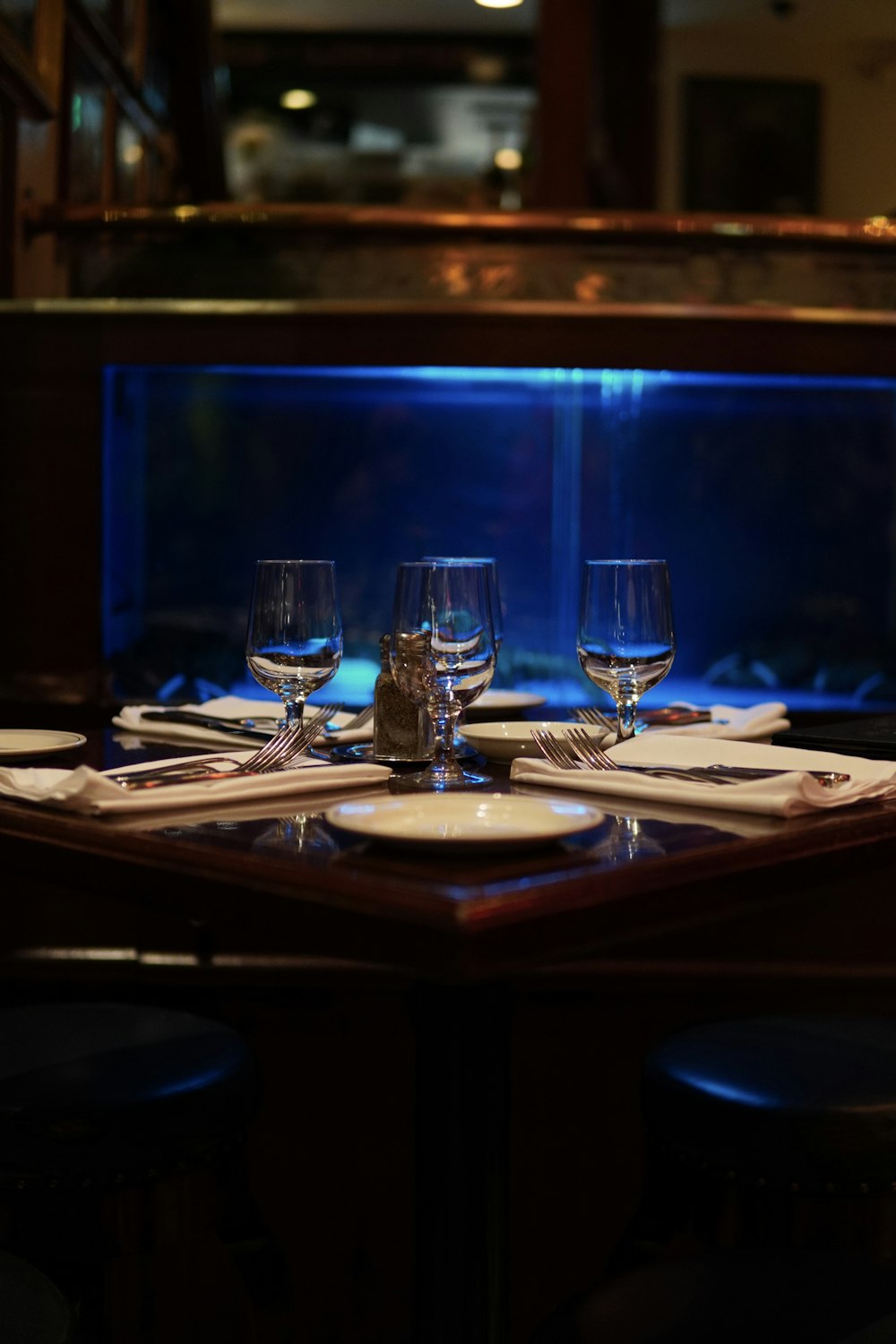 a table set with wine glasses and place settings