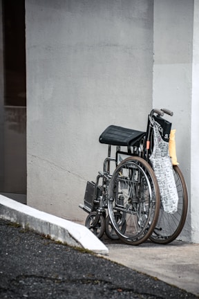 A variety of wheelchair models lined up neatly in a bright showroom.