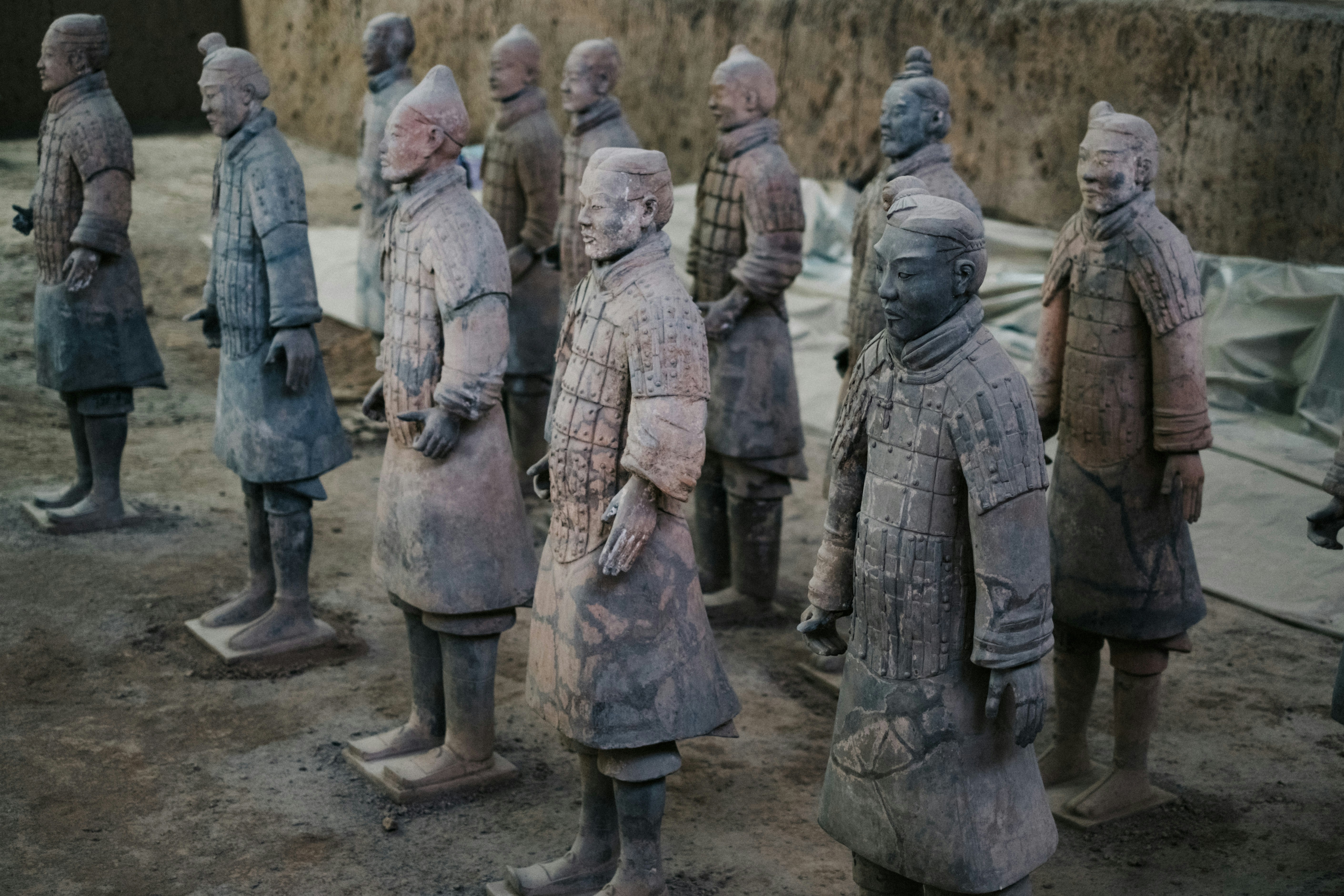 a group of statues of men standing next to each other