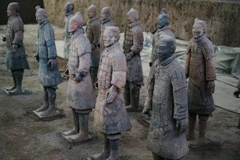 a group of statues of men standing next to each other