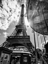 A sleek, futuristic black-themed photo of a famous Paris landmark at night, highlighting exclusive tourism photography.
