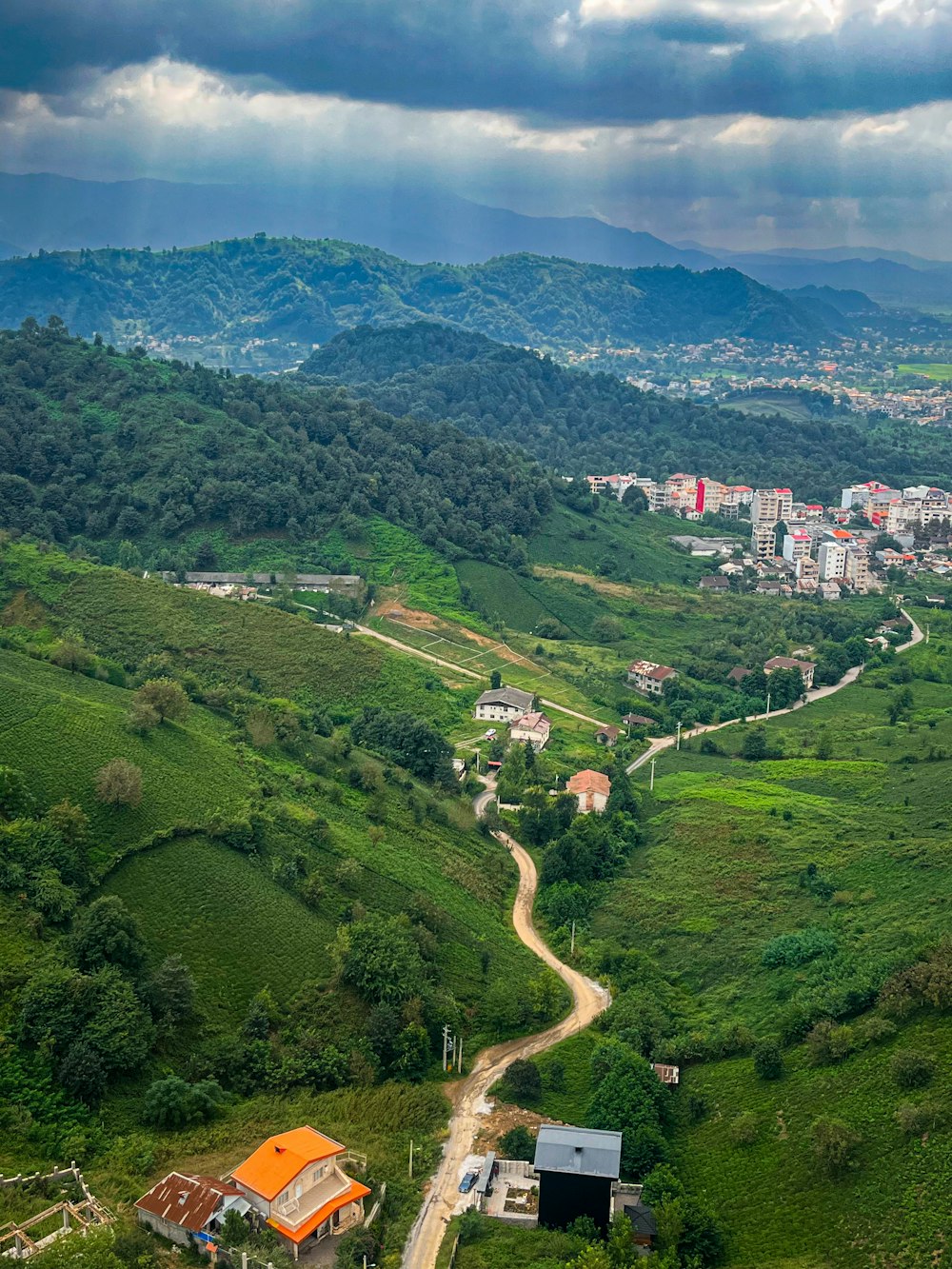 a scenic view of a small town in the mountains